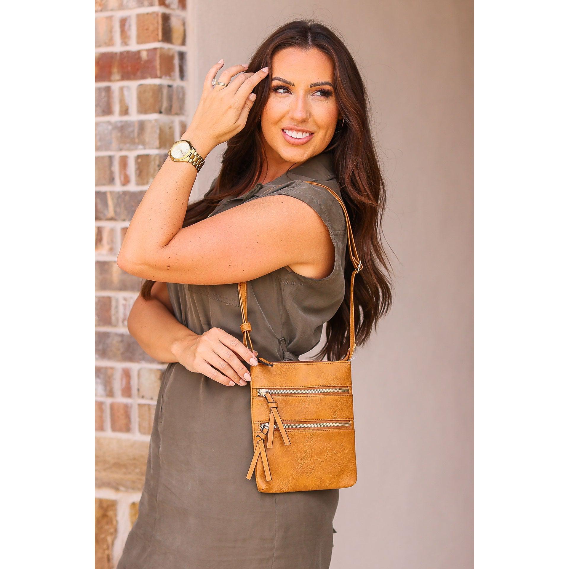 Envelope style crossbody bag with multiple zipper compartments