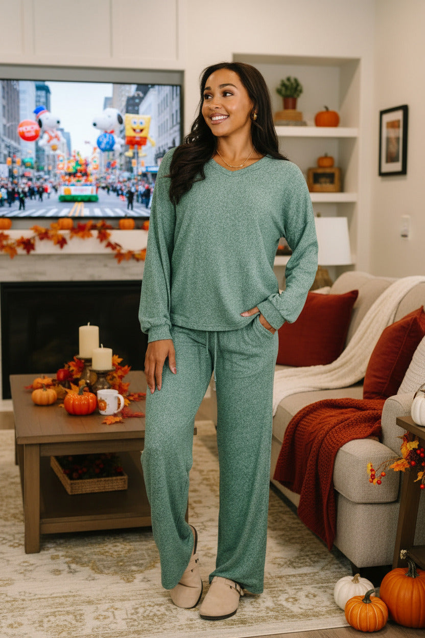 Woman wearing a teal loungewear set in a living room setting.
